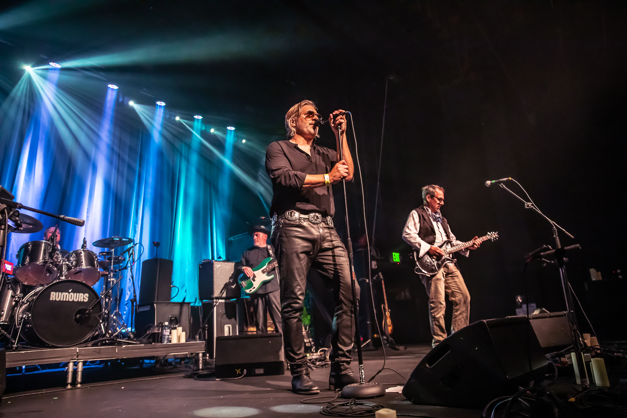 Singer in leather pants mid-song